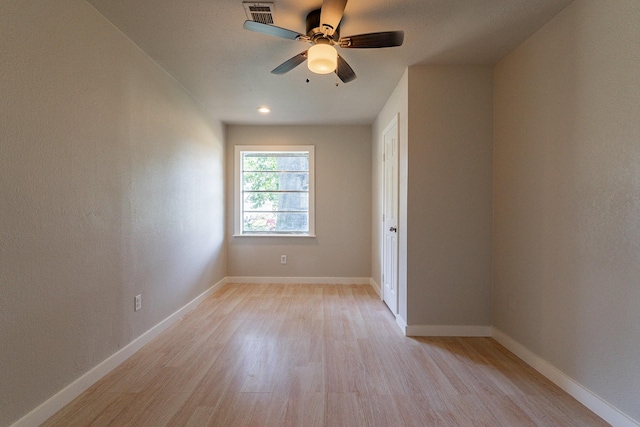 empty room with light hardwood / wood-style floors and ceiling fan