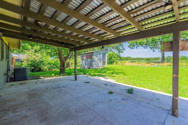 view of patio with central air condition unit and a storage shed