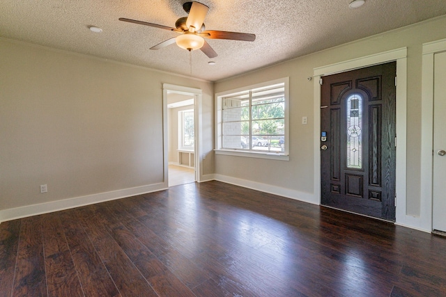 foyer featuring ceiling fan, dark hardwood / wood-style flooring, and a textured ceiling