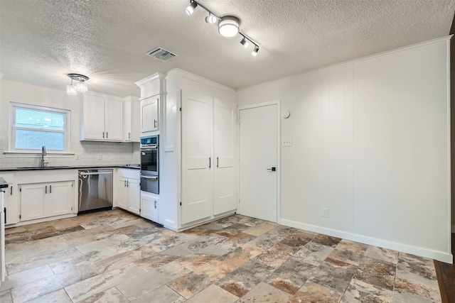 kitchen with stainless steel appliances, white cabinetry, sink, and decorative backsplash