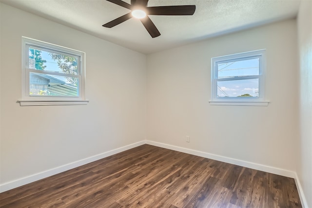 unfurnished room featuring ceiling fan, dark wood-type flooring, and a textured ceiling