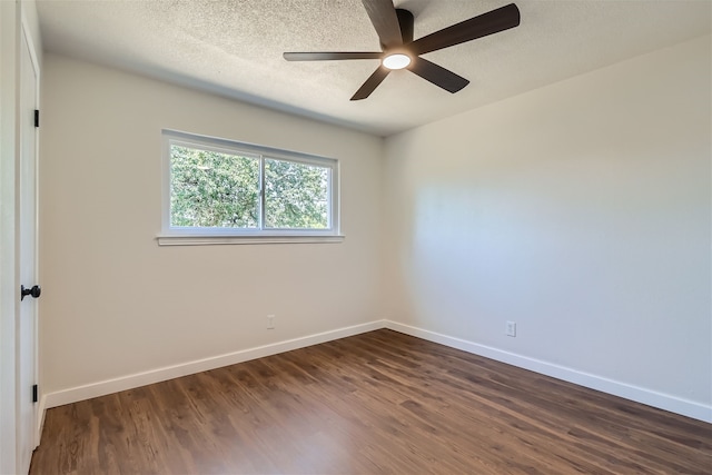 spare room featuring ceiling fan, dark hardwood / wood-style flooring, and a textured ceiling