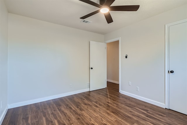 unfurnished room with dark hardwood / wood-style floors and ceiling fan