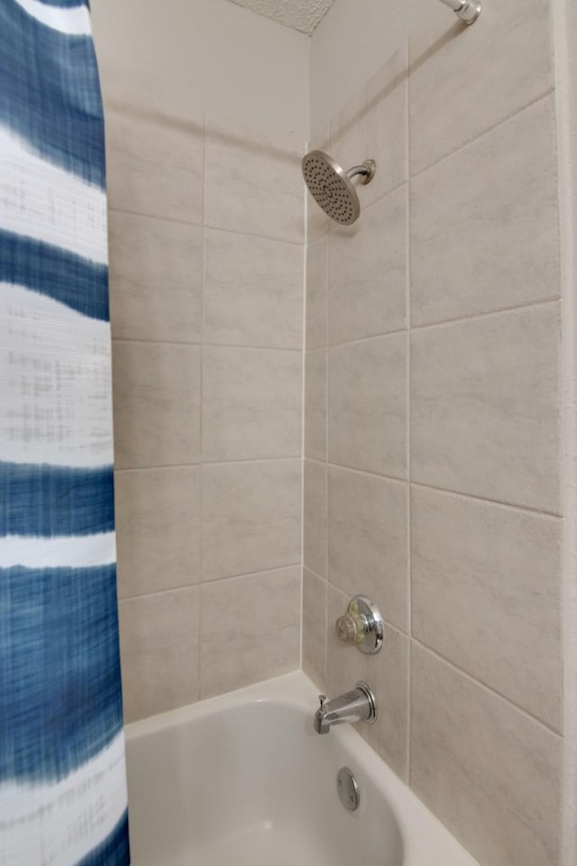 bathroom with shower / bathtub combination with curtain