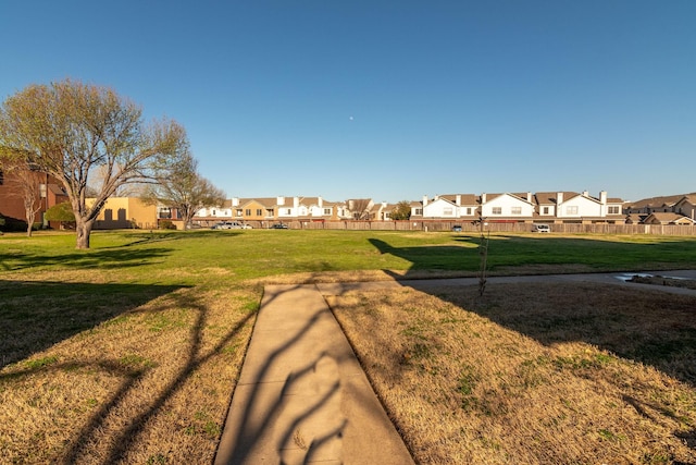 view of property's community with a lawn