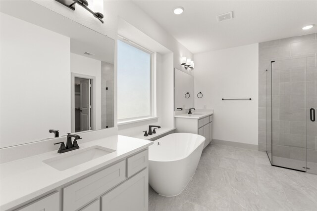 5249 Deep Creek Dr, Fort Worth, TX 76179 - bathroom featuring a shower stall, a freestanding bath, two vanities, recessed lighting, and baseboards
