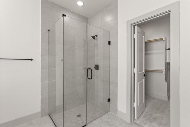 bathroom featuring a shower with shower door