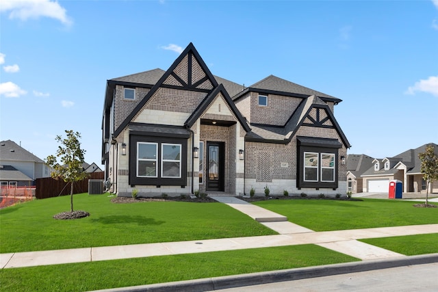 view of front facade with a garage, central AC, and a front lawn