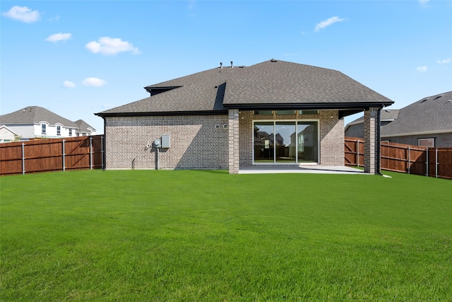 back of property featuring a patio and a lawn