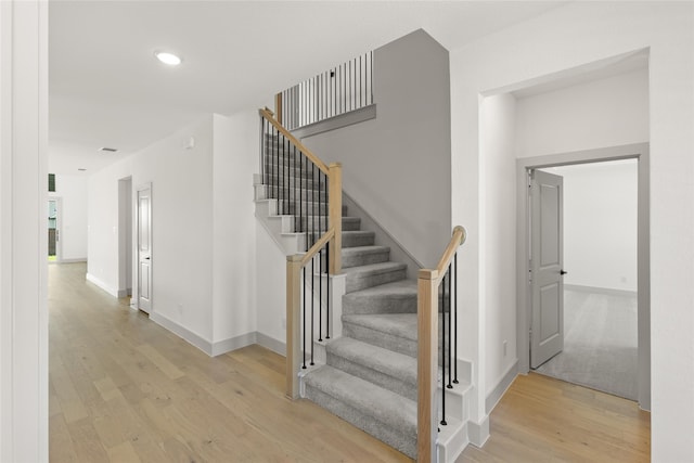 stairs with hardwood / wood-style floors