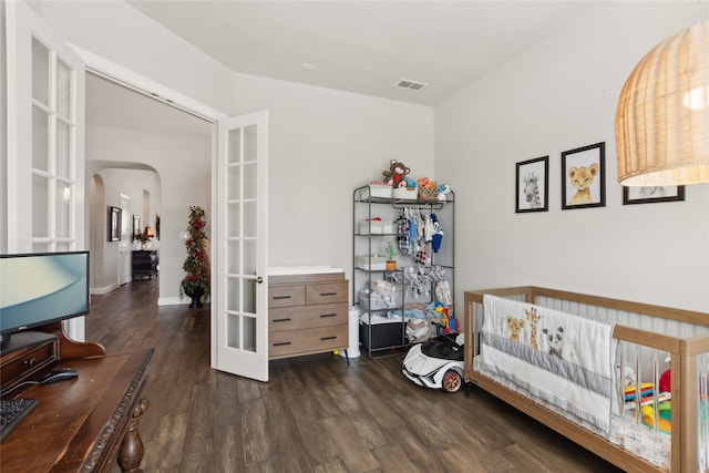 bedroom featuring dark wood-type flooring and french doors