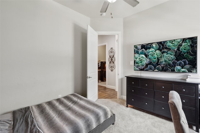 bedroom featuring ceiling fan and light carpet