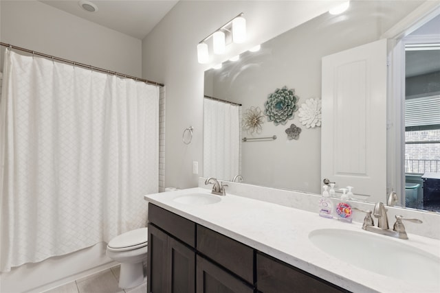 full bathroom with tile patterned floors, vanity, shower / tub combo, and toilet