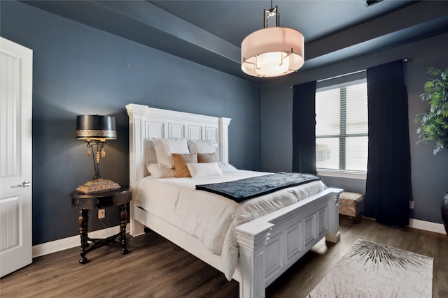 bedroom with dark wood-type flooring