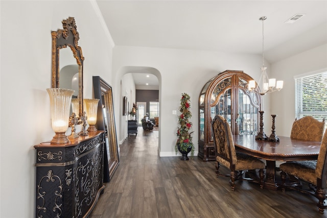 dining room featuring a chandelier and dark wood-type flooring