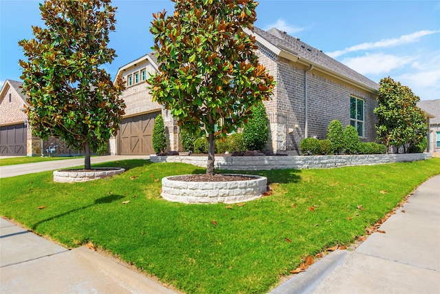 view of front facade with a garage and a front lawn