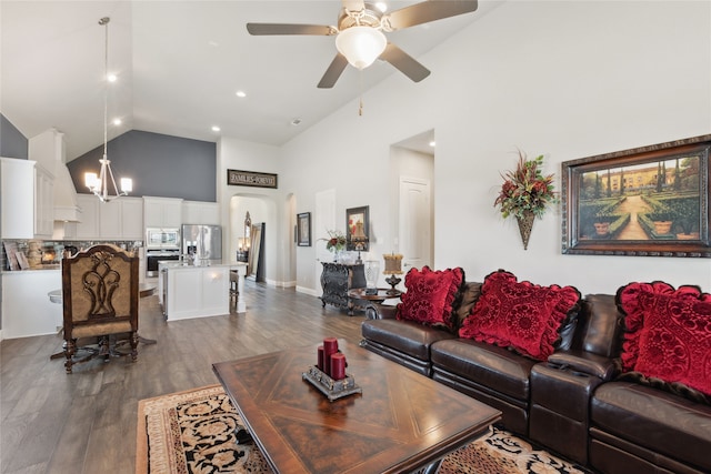 living room featuring dark hardwood / wood-style floors, ceiling fan, and high vaulted ceiling