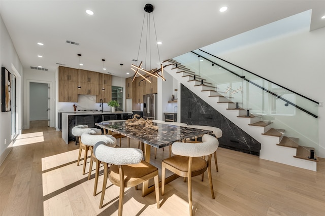 dining room featuring light hardwood / wood-style floors and sink