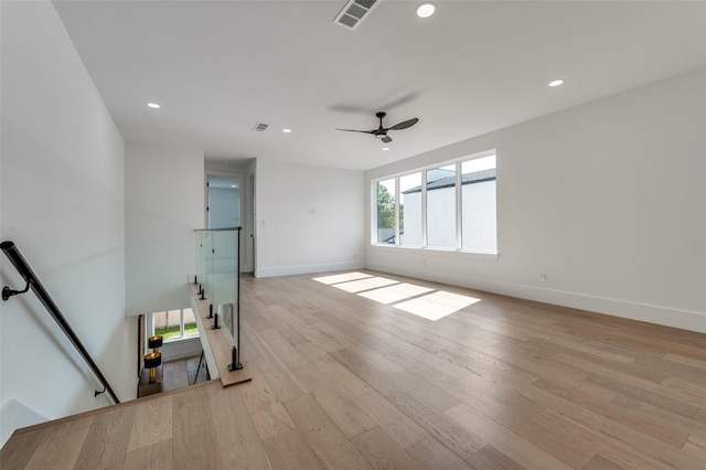 empty room with light wood-type flooring and ceiling fan