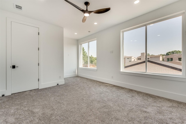 spare room featuring ceiling fan and carpet floors