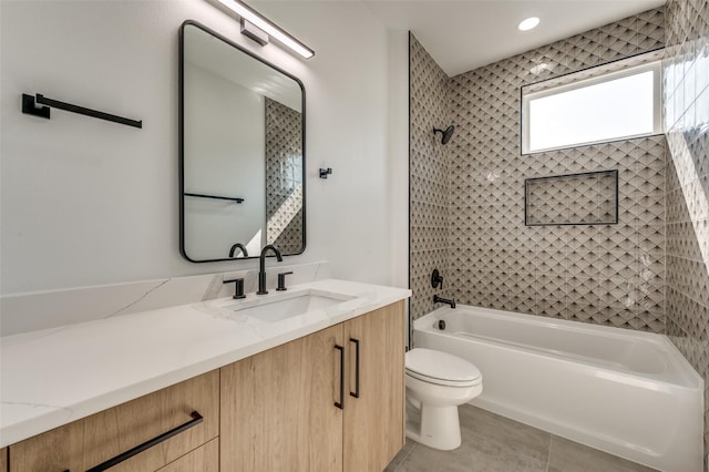 full bathroom with tile patterned flooring, vanity, toilet, and tiled shower / bath combo