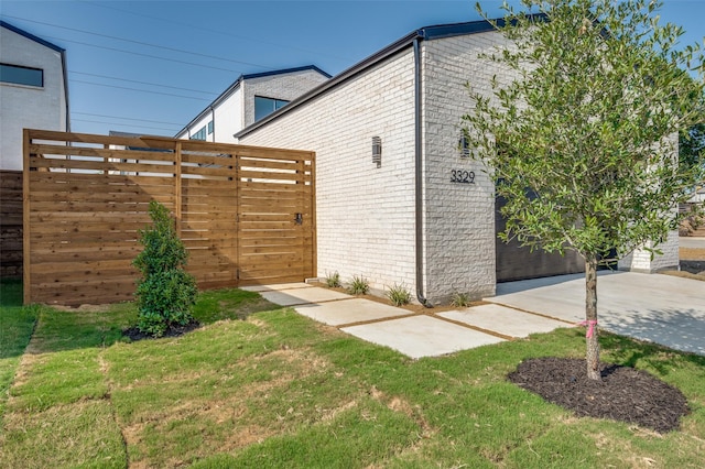 view of side of home with a yard