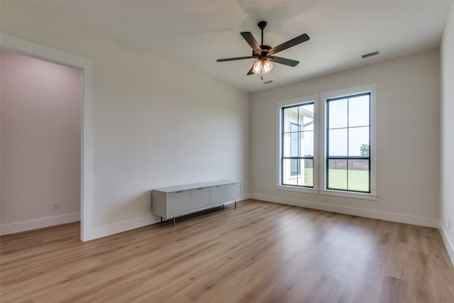 spare room featuring ceiling fan and light hardwood / wood-style flooring