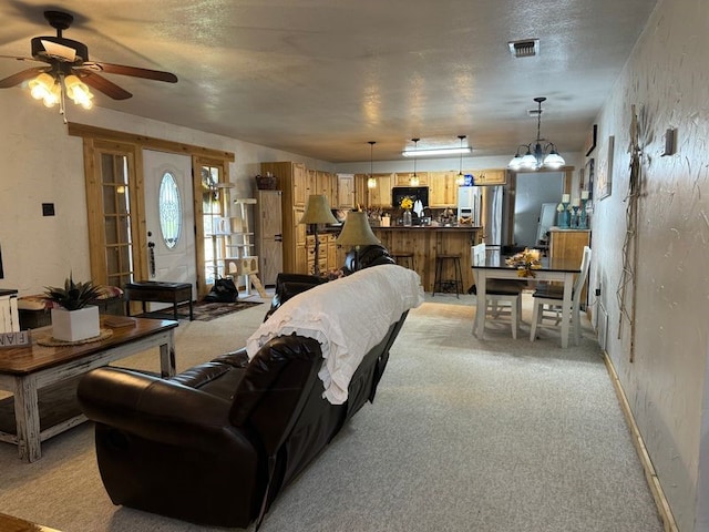 living room featuring light carpet and a textured ceiling