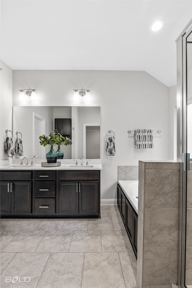 bathroom with double vanity, independent shower and bath, tile patterned floors, and vaulted ceiling