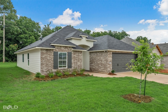 view of front of property featuring a garage and a front lawn