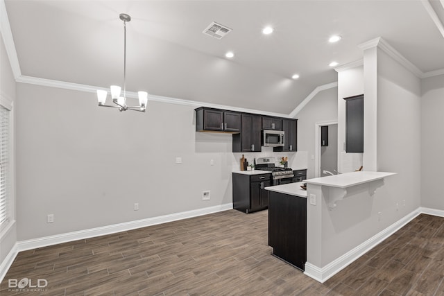 kitchen with a chandelier, stainless steel appliances, hardwood / wood-style floors, ornamental molding, and kitchen peninsula