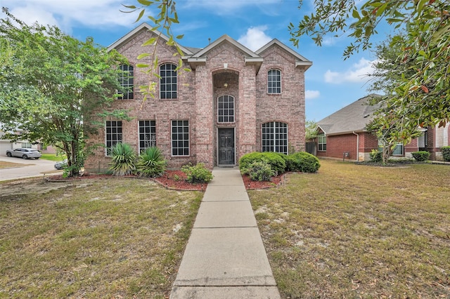 traditional home with brick siding and a front yard