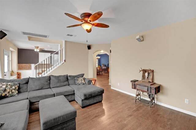 living room with ceiling fan and wood-type flooring