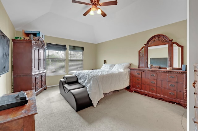 bedroom with vaulted ceiling, a ceiling fan, and light carpet