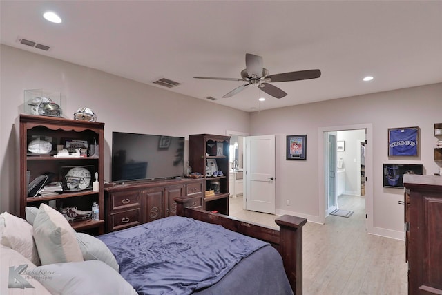 bedroom with ensuite bathroom, light hardwood / wood-style flooring, and ceiling fan