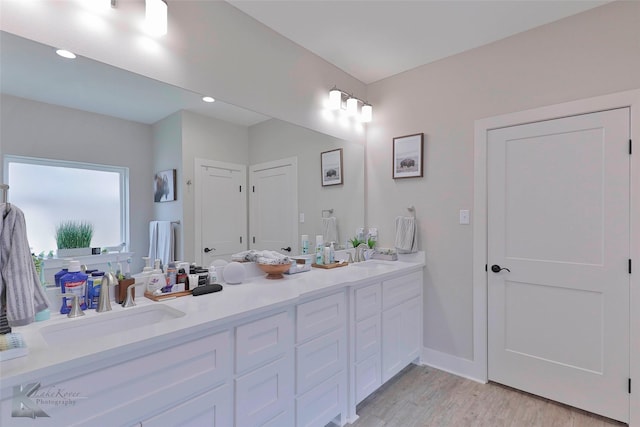 bathroom featuring vanity and wood-type flooring