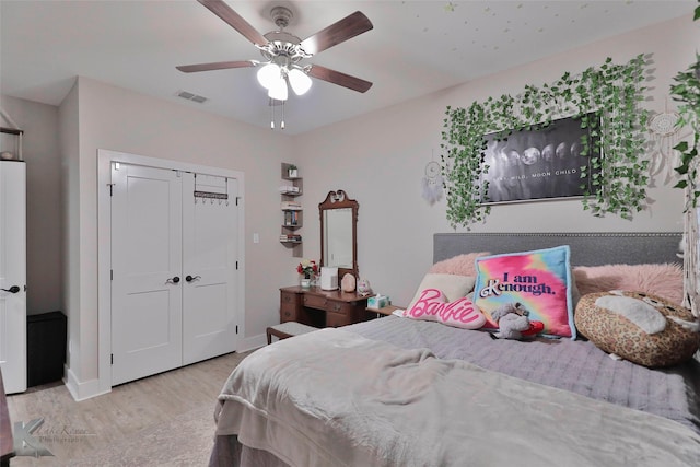 bedroom featuring ceiling fan, a closet, and light hardwood / wood-style flooring