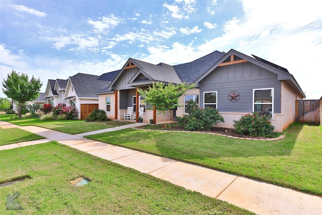 craftsman inspired home with a front lawn