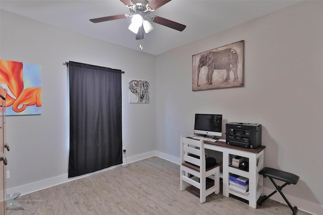 home office with light hardwood / wood-style flooring and ceiling fan