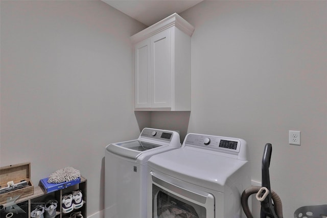 laundry area featuring washing machine and dryer and cabinets