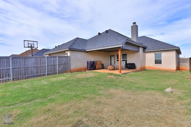 back of property featuring a patio area and a lawn