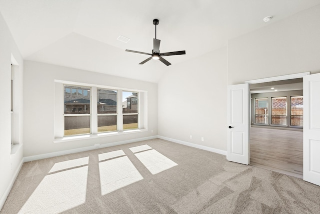 living room with hardwood / wood-style flooring, ceiling fan, a stone fireplace, and vaulted ceiling