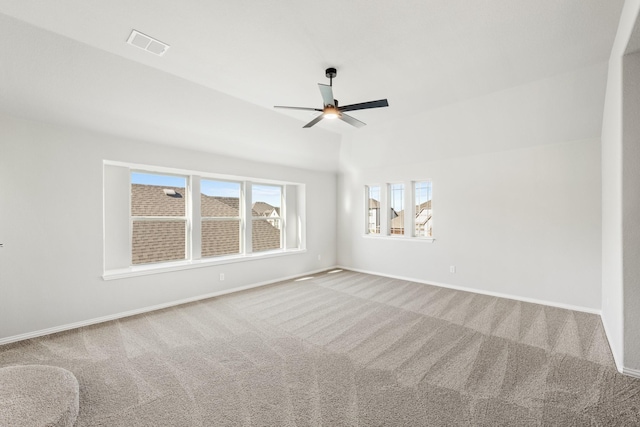 living area featuring light colored carpet, plenty of natural light, and lofted ceiling