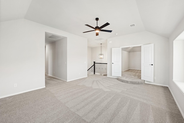 unfurnished living room with ceiling fan, light carpet, and vaulted ceiling