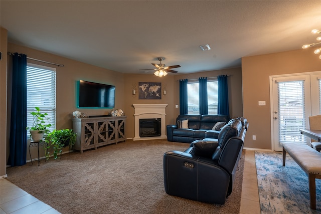 tiled living room featuring ceiling fan