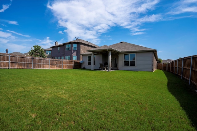 back of property featuring a patio and a lawn