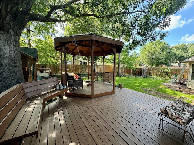 wooden terrace featuring a gazebo and a yard