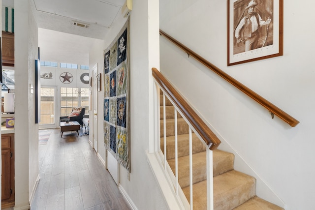 stairs featuring wood-type flooring