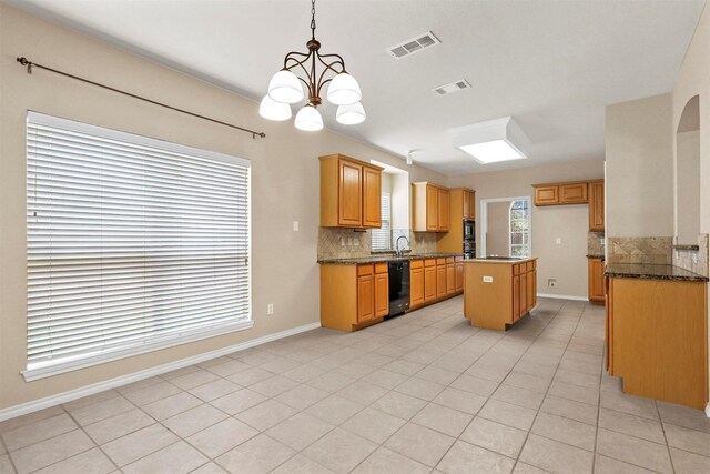 unfurnished living room with crown molding, ceiling fan with notable chandelier, and light tile patterned floors