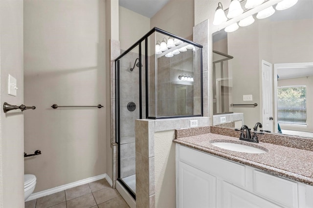 bathroom featuring vanity, toilet, an enclosed shower, and tile patterned flooring